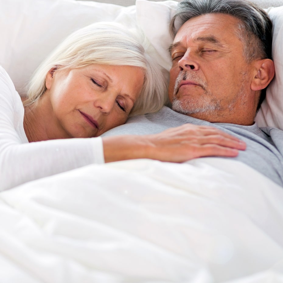 Senior couple sleeping peacefully thanks to no more snoring